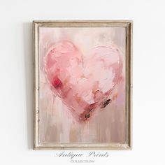 a pink heart painting hanging on the wall