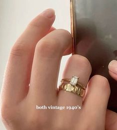 a hand holding a cell phone with a gold ring on it's finger and the text, both vintage 1940's