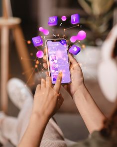 a woman holding a smart phone in her hands with icons coming out of the screen