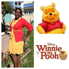 a woman standing next to a winnie the pooh sign