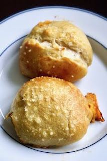 two muffins sitting on top of a white plate