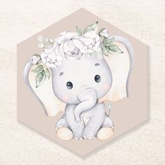 an elephant with flowers on its head sitting in front of a hexagon