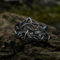 a silver ring sitting on top of a rock