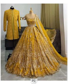 a yellow wedding gown with gold sequins on the skirt and jacket is displayed in front of a mannequin