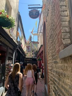 several people walking down an alley way