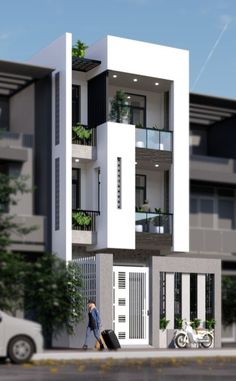 two people walking down the street in front of a building with balconies on it