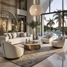 a living room filled with white furniture and large windows next to a palm tree covered swimming pool