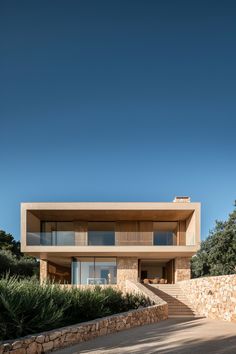 the house is made out of stone and has stairs leading up to it's upper level