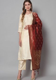 Product Details Beige and Rose Red Solid Kurta with Trousers with dupatta Kurta design:  * Solid * Straight shape * Regular style *Round neck, three-quarter regular sleeves * Calf length with straight hem * Silk blend fabric Trousers design:  * Solid Trousers *Elasticated waistband * Slip-on closure Material & Care Kurta Material: Silk Blend Trouser Material: Silk Blend Dupatta Material: Banarasi Silk Hand Wash items includes One piece Kurta One piece Dupatta One piece Trouser Note:- Please see the size chart in the image to choose a perfect size. Please feel free to ask any questions regarding this item WE ALSO ACCEPT CUSTOMISATION AS PER CUSTOMER REQUESTS. Sheer Dupatta Sets For Puja On Eid, Sheer Dupatta Sets For Puja And Festivals, Fitted Sets With Dupatta For Puja, Sheer Dupatta Set For Puja And Eid, Sheer Dupatta Set For Eid Puja, Sheer Dupatta Sets For Puja During Eid, Festive Sets With Sheer Dupatta For Puja, Eid Puja Set With Sheer Dupatta, Diwali Puja Set With Sheer Dupatta