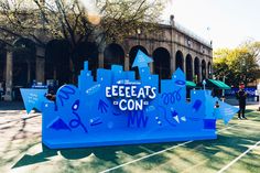 a blue sign that says eeeeeats con on it