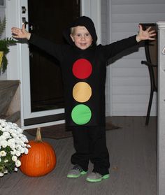 a young boy dressed in a traffic light costume