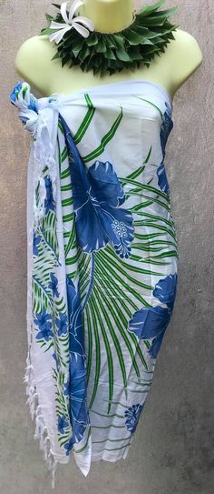 "This sarong/wrap is great for the summer time. This is a 100% rayon sarong, beautiful prints suited for your colorful personality . This versatile sarong can be worn in different ways. Sarong measures approximately 65\" x 43\" lightweight fringe rayon. Please note color, size, and design will vary due to the handmade nature of this item. Guaranteed fast shipping." Traditional Printed Sarong For Summer, Green Hawaiian Sarong For Vacation, Green Hawaiian Sarong For Summer, Green Tropical Sarong For Poolside, Blue Batik Print Sarong For Summer, Tropical Green Sarong For Poolside, Summer Blue Batik Print Sarong, Hawaiian Printed Sarong For Beach Cover-up, Tropical Printed Sarong For Beach Season