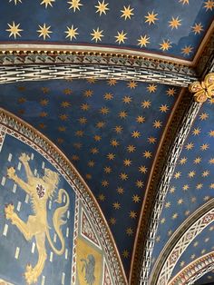 an ornate ceiling with stars and lions painted on it