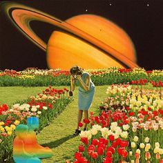 a woman in a blue dress is standing in a field with tulips and an orange ring