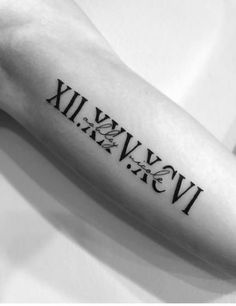 a tattoo with roman numerals and the word love on it's arm