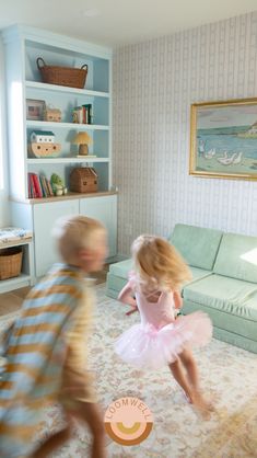 two young children are playing in the living room