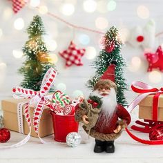 a santa clause figurine next to christmas decorations