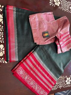 This is a beautiful Light weight warm silk saree with designer stitched blouse. This saree is hand woven. This saree would be worn for almost any occasion. Color of the saree is dark green with bright red border bright red weaving with all over floral thread weaving. Blouse is perfectly stitched and designed and can fit to size 36-44inches Chest. Ships immediately. Designer Tussar Silk Pre-draped Saree With Border, Designer Cotton Silk Pre-draped Saree With Border, Anarkali Blouse Piece With Border In Tussar Silk, Anarkali Tussar Silk Blouse Piece With Border, Semi-stitched Cotton Silk Blouse Piece With Border, Festive Designer Blouse Piece With Border, Designer Festive Blouse Piece With Border, Designer Wear Festive Blouse Piece With Border, Designer Blouse Piece With Border For Diwali