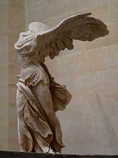 an angel statue with its wings spread out