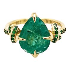 Glamorously bold and unabashedly seductive. This showstopper one of a kind ring features a 4ct natural pear cut Emerald poised between sharp eagle style talons and embraced by powerful-gold, emerald encrusted ropes, converging to two knots on either side of the luscious, one-of-a-kind stone. Handcrafted in 18ct yellow gold Natural Zambian Emerald Pear cut Emerald set down the knotted band Ethically sourced gold Size Q AUD/UK 8 US *can be resized at request Please carefully view the natural inclusions of emerald in photos** if you desire a higher quality stone please contact to view more options to suit your increased budget. Customisation available please contact our customer service team for gold or stone variations. Every OHLIGUER jewel & is custom made to order and requires three to six Diamond Knot, Contemporary Engagement Rings, Emerald Cut Engagement, Modern Engagement Rings, Emerald Engagement Ring Cut, Diamond Free, Zambian Emerald, Modern Ring, Engagement Ring Cuts