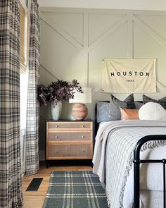 a bed room with a neatly made bed and a rug on the floor next to it