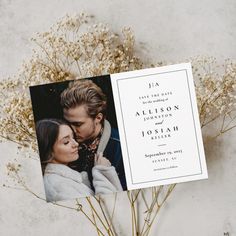 an image of a wedding card with flowers in the foreground and a couple's photo on it