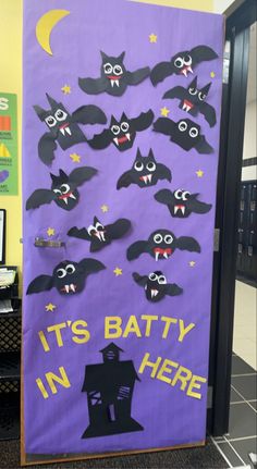 a bulletin board decorated with bats and the words it's batty in here