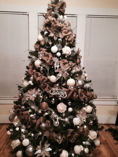 a christmas tree decorated with ornaments and ribbons