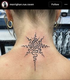 a woman's back neck with a tattoo design on the upper part of her neck