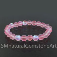 Matte Angel Aura Quartz Beaded Bracelet, Stretch Bracelet, Mystic Baby Pink Aura Quartz Bracelet, Matte Mystic Aura Quartz Beads Bracelet Gemstone :  Angel Aura Quartz Beads Size : 8 mm Bracelet Type : Stretchable Gemstone Creation : Lab Created Iridescent 8mm Round Bead Jewelry, Spiritual Iridescent Jewelry With 8mm Beads, Adjustable Iridescent Jewelry With 8mm Beads, Iridescent Round Beads Crystal Bracelet For Jewelry Making, Iridescent Beaded Bracelets With Colorful Beads As Gift, Iridescent Beaded Bracelets As Gift, Spiritual Iridescent Beaded Bracelets, Spiritual Pink Round Beads Bracelets, Spiritual Pink Round Beaded Bracelets