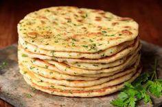 a stack of flatbreads with parsley on top