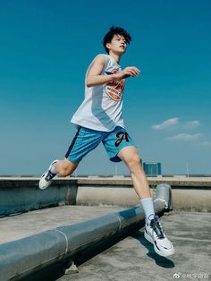 a man is running on the street in shorts and sneakers with his feet spread out