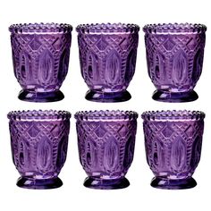 six purple glass goblets sitting next to each other