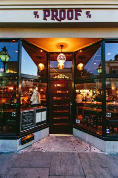 the front entrance to a restaurant that is lit up at night