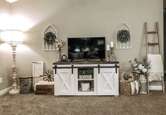 a living room filled with furniture and a flat screen tv on top of a wooden stand