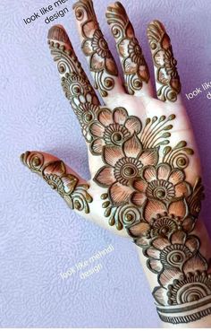 the hand is decorated with henna designs