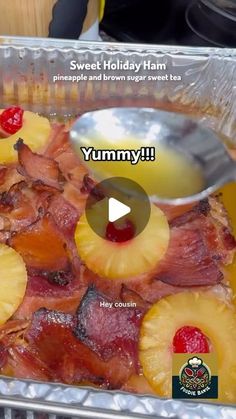 a pan filled with bacon and pineapples on top of a counter next to a spoon