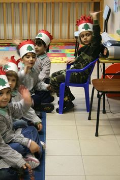 children wearing christmas hats sitting on the floor