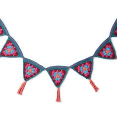 a crocheted triangle with tassels is shown in pink and blue colors