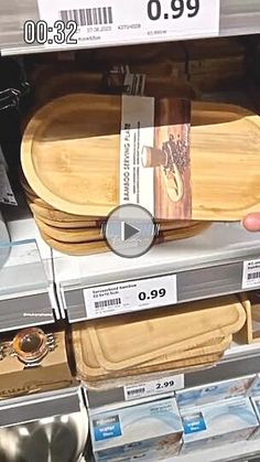 a person holding a watch in their hand near some wooden trays and other items