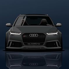 the front view of an audi car on a dark background with reflection in the floor