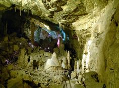 the inside of a cave filled with lots of rocks and ice hanging from it's ceiling