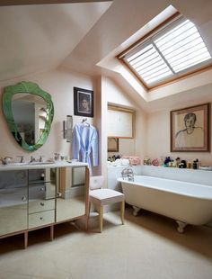 a bath room with a tub a sink and a mirror on the wall in it