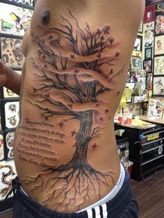 a man with a tree tattoo on his stomach