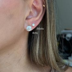 a close up of a person wearing some kind of earring with diamonds on it