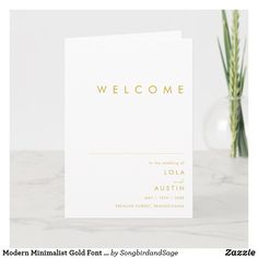 a white welcome card with gold foil on the front and bottom that reads, welcome