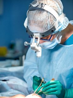 a surgeon performing surgery on a patient in an operating room