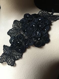 a black lace collar with flowers on it