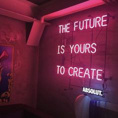 a neon sign that reads, the future is yours to create absolut '