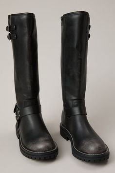 Edgy and sleek, these tall moto boots feature two small buckles at the top, a bold decorative buckle around the ankle, and a convenient full inside zipper. Perfect for adding a touch of rebel style to any outfit. White Dress Boots, White Dress Skirt, Fall Footwear, Boots Leggings, Booties For Women, Boots And Leggings, Skirts With Boots, Trending Boots, Fall Shoes